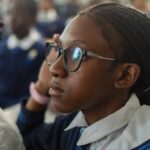 Schoolgirl wearing glassing looking expectantly ahead